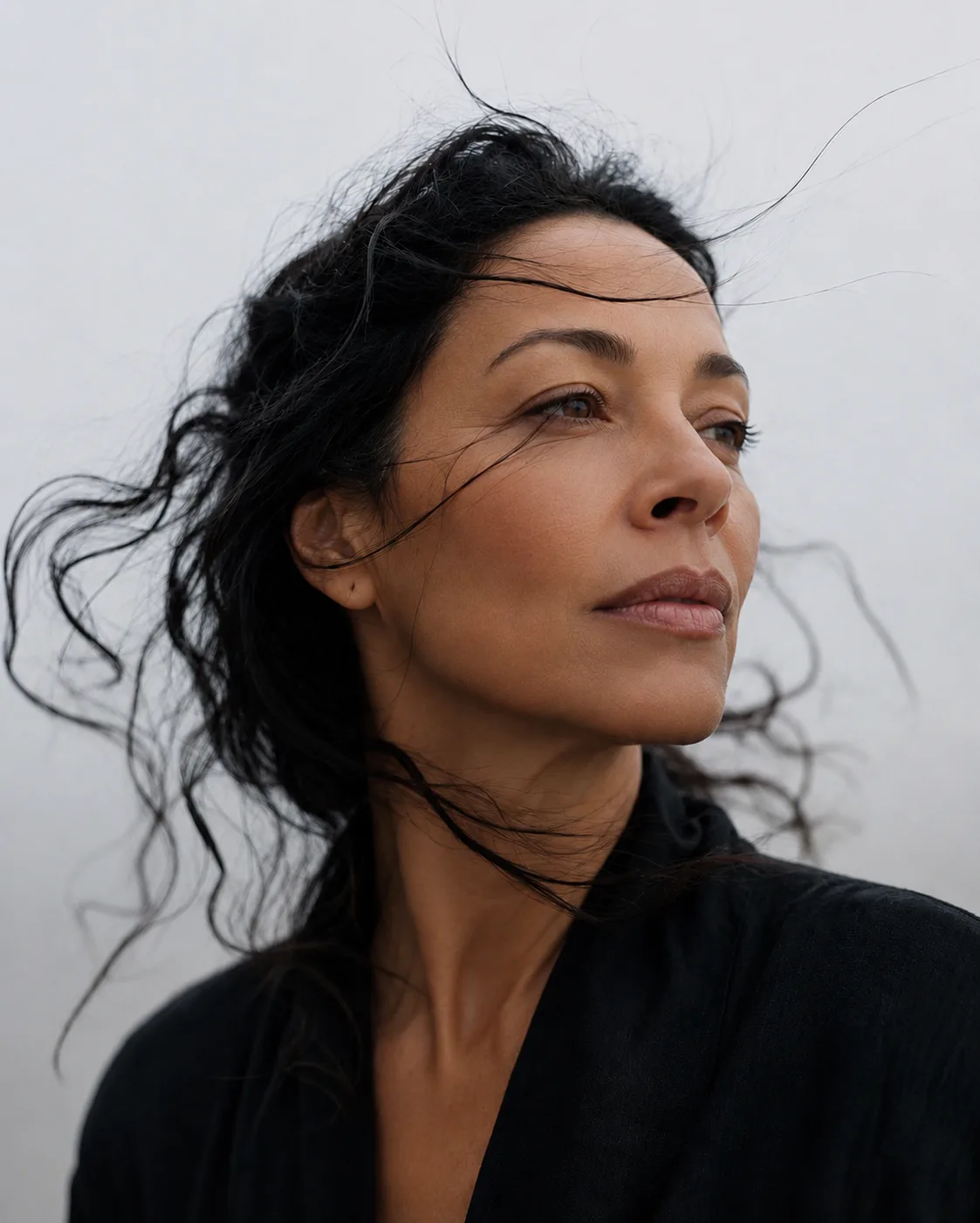 Portrait — wind-swept hair, calm gaze